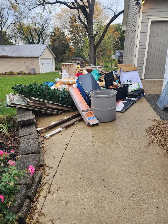 Dumpster being loaded with debris for Estate Cleanout Dumpster Rental in Highland